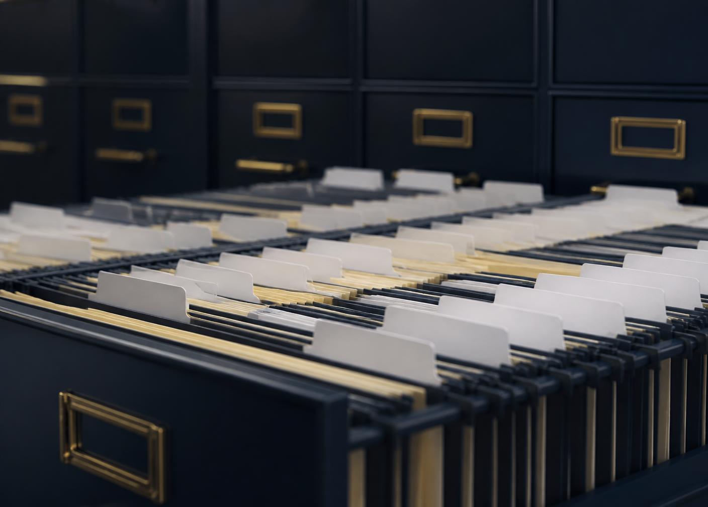 Rows of labeled document folders organized in a records cabinet